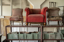 Many Vintage Armchairs Standing At The Shelves At The Workshop
