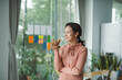 © Marc Tran/Stocksy - Happy young Asian woman freelancer work stand at office calling
