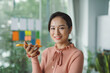 © Marc Tran/Stocksy - Young businesswoman work stand at a office desk talking speaking