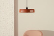 © Marcos Osorio/Stocksy - Ceiling lamp above an armchair