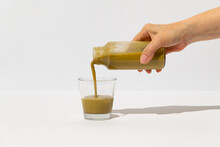 Woman Poruing Chinese Matcha Healthy Superfood Drink Into Glass