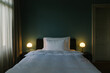 © VISUALSPECTRUM/Stocksy - Dark Bedroom Illuminated by Pretty Lamps