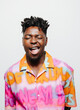 © VICTOR TORRES/Stocksy - Cheerful black man in colorful shirt making faces