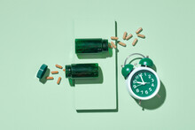 Pile Pills, Green Bottles And Green Alarm Clock On Green