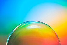 Transparent Soap Bubble On Rainbow Background.