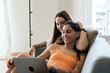 © Malquerida Studio/Stocksy - Relaxed couple browsing laptop at home