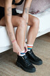 © Malquerida Studio/Stocksy - anonymous woman puts on rainbow socks