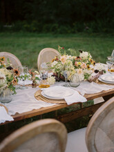 Close Up Of Wedding Reception Table Setting With Flower Arrangements