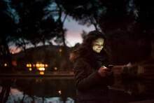 Happy Woman Using Smartphone At Sunset