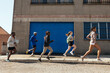 © BONNINSTUDIO/Stocksy - Diverse sportspeople running on street