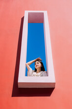 Woman In A Huge Window Frame