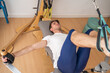 © Luis Velasco/Stocksy - Young Man In A Physiotherapy Center.