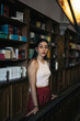 © Pedro Merino/Stocksy - Beautiful woman surprised in an old bookstore