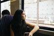© Pedro Merino/Stocksy - Thoughtful girl traveling by train