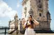 © Pedro Merino/Stocksy - Young tourist woman taking selfies with her smartphone at Belem tower