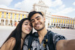 © Pedro Merino/Stocksy - Couple taking a selfie in the Commerce Plaza in Lisbon
