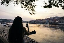 Woman Taking Photos On The Douro Riverside In Porto