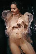 Fashion Portrait Of Woman In Transparent Dress In Black Bath