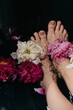 © Liliya Rodnikova/Stocksy - Anonymous lady taking bath with fresh peonies