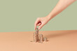 © Yaroslav Danylchenko/Stocksy - Cents being put in stacks by woman.