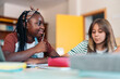 © Santi Nuñez/Stocksy - Two Students studying in school