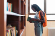 © Santi Nuñez/Stocksy - Student reading a book in a library