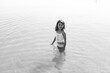 © Maria Manco/Stocksy - black and white photo of child in lake