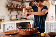 © Lucas Ottone/Stocksy - Woman cooking and seasoning with lemon