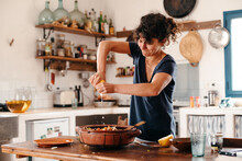 Woman Cooking And Seasoning With Lemon