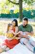 © Serena Burroughs/Stocksy - Family with toddler and newborn baby outdoors on summer night