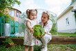 © AD Astra Team/Stocksy - Mom and daughter are picking cabbage in the garden