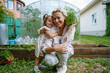 © AD Astra Team/Stocksy - Mom and daughter are picking cabbage in the garden