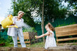 © AD Astra Team/Stocksy - Mom and daughter watering the garden