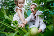 © AD Astra Team/Stocksy - Mom and daughter pick vegetables in the garden