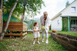 © AD Astra Team/Stocksy - Mom and daughter are picking cabbage in the garden