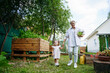 © AD Astra Team/Stocksy - Mom and daughter are picking cabbage in the garden