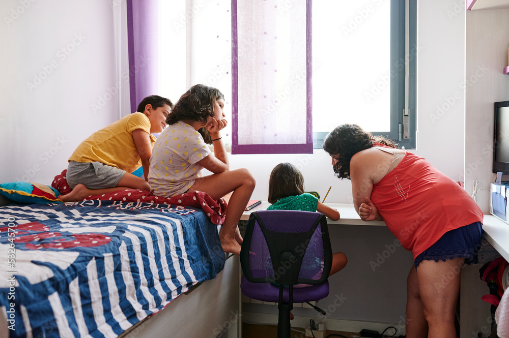 Little girl drawing with her family watching Stock Photo | Adobe Stock