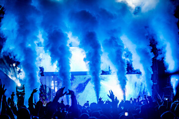 Cryo cannons going off at an electronic music concert with blue light