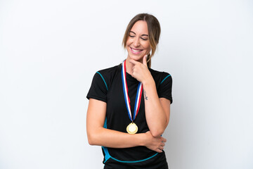 Wall Mural - Young caucasian woman with medals isolated on white background looking to the side