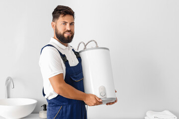 Poster - Male plumber with boiler in bathroom