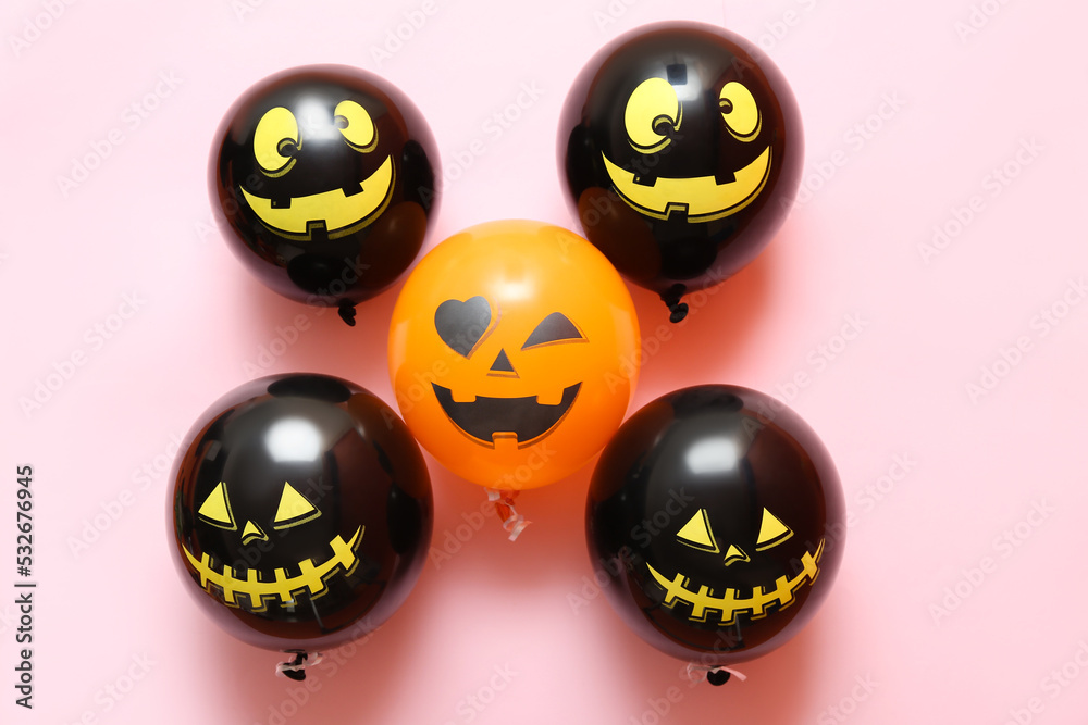 Funny Halloween balloons on pink background