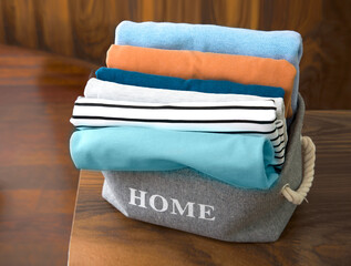 Wall Mural - Colorful autumn laundry.Stack of clothes, textile. Clothing pile on wooden table.