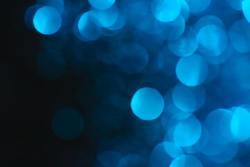 blau bokeh on a black background.Wallpaper Shiny phone.Festive Christmas background. Glowing blau bokeh. Shining bokeh background.