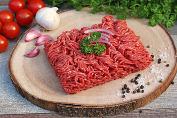 Minced meat on a wooden board.