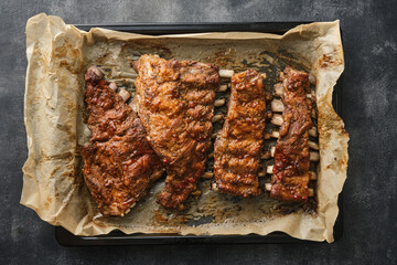 Wall Mural - Roasted pork ribs on a baking sheet. View from above