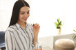© New Africa - Young woman with glass of water and vitamin capsule indoors. Space for text