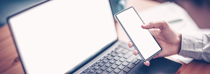 Businessman sitting at the table and using smartphone.