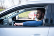 © Panorama - Young business man driving a car