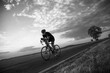 © Solid photos - Young sports man cycling with bicycle on the road in summer in black and white