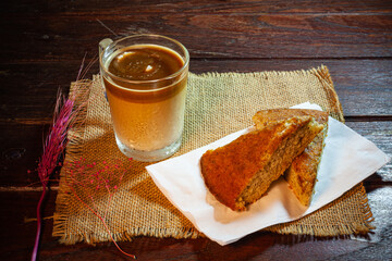 Wall Mural - Coffee and banana cake on vintage wooden table.